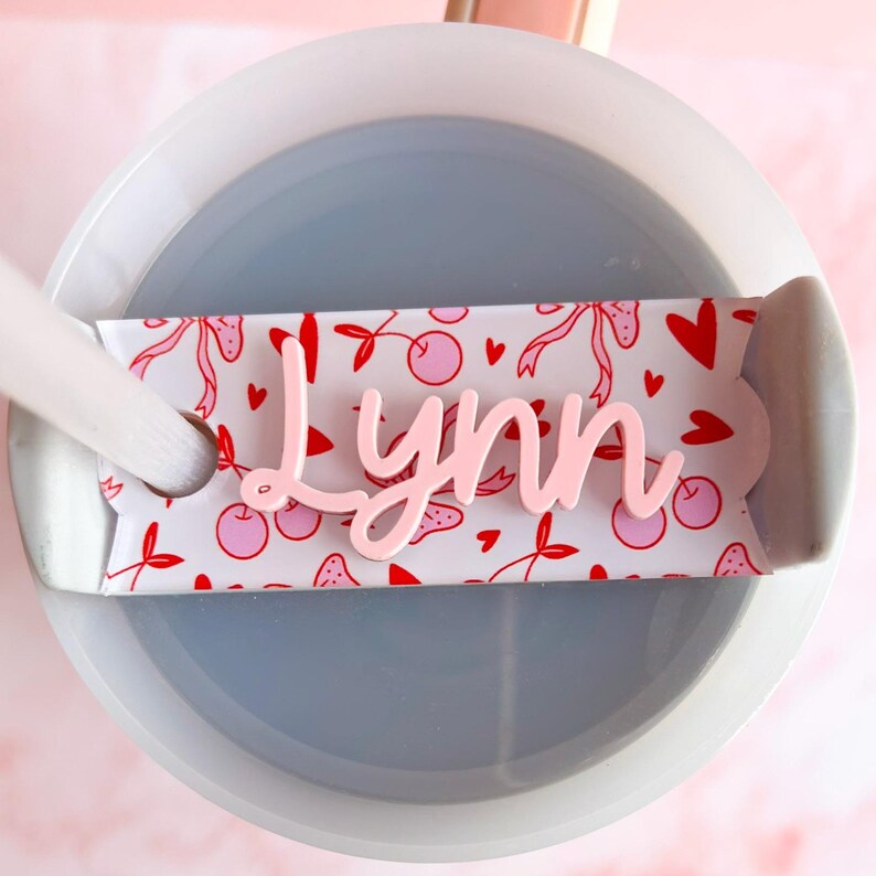 a cup of water with a spoon inside of it