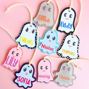 a collection of personalized name tags with cartoon-like faces, each featuring a different name.
