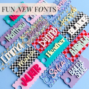 a collection of colorful name tags or tags with various names written on them, arranged in a visually appealing manner.