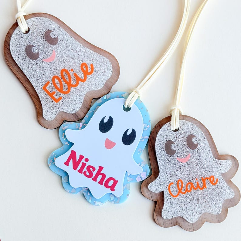 three personalized name tags with a ghost theme, each with a different name.