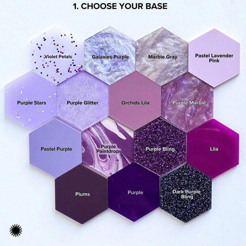 a collection of twelve hexagonal tiles, each with a different color and pattern, arranged in a grid-like pattern. The tiles include pastel shades of purple, such as lavender, mint, and plum, as well as glittery purple and marble gray. The tiles also feature pastel pink and pastel purple, as well as glittery purple and marble gray. The image does not contain any text, and the arrangement of the tiles suggests a deliberate and organized presentation.