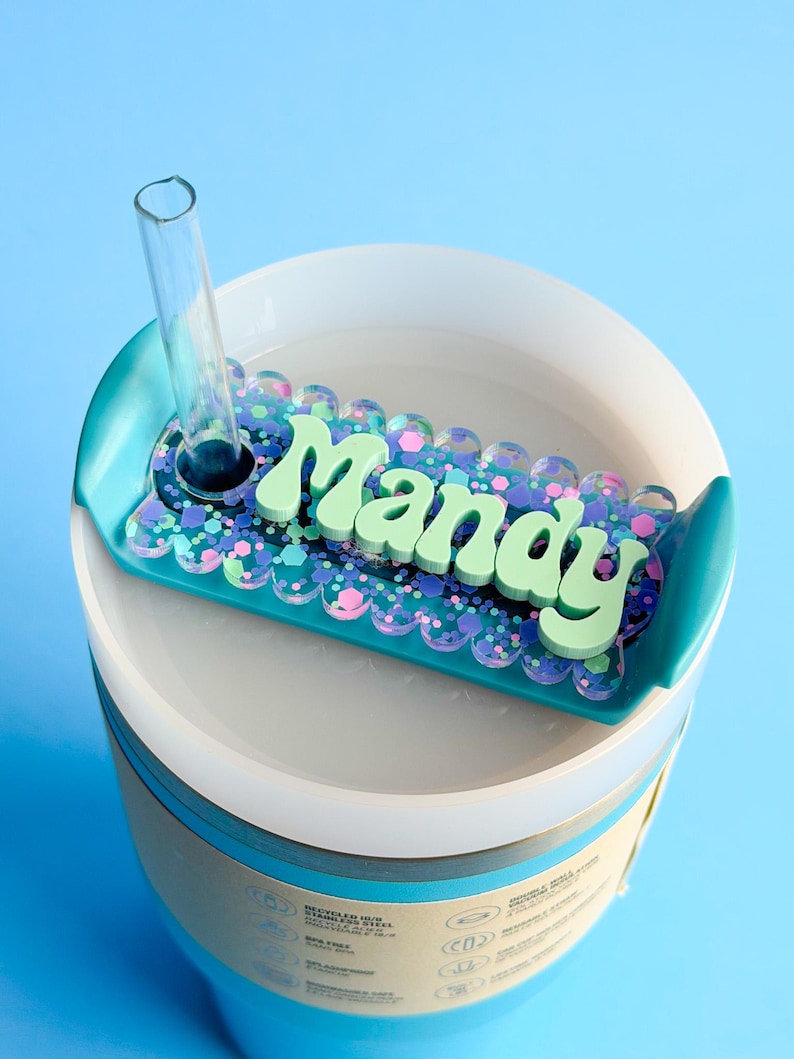 A blue and white container with a clear lid, featuring a decorative label that says "Manay" in a playful font.