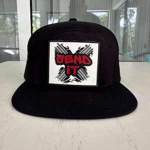 May include: Black and white baseball cap with a white patch that says "SEND IT" in red letters. The patch features a graphic of tire treads.