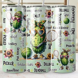May include: Three green pickle-themed stainless steel tumblers with various pickleball-related words and phrases printed on them. The tumblers feature cartoon pickles wearing sunglasses and playing pickleball.