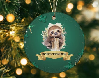 May include: A green round Christmas ornament with a white and green snowflake pattern. A cute cartoon sloth is holding onto a branch with the text "Merry Christmas" in gold lettering on a gold ribbon.