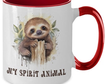 May include: White ceramic coffee mug with a red rim and handle. The mug features a watercolor illustration of a sloth holding onto a tree branch. The text "MY SPIRIT ANIMAL" is printed in brown below the sloth.