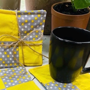 May include: A set of three ceramic mugs with a speckled, matte finish. The mugs are in shades of cream, light gray, and dark gray. Each mug has a simple, minimalist design, perfect for coffee or tea.
