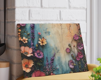 May include: A floral art print with a textured backdrop in blue, beige, and orange tones. The artwork displays a range of colourful flowers, including pink, purple, and orange blooms, forming a vibrant and artistic composition.