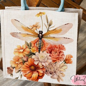 May include: A tote bag with a watercolor design of a dragonfly and flowers. The dragonfly is orange and brown with delicate wings. The flowers are in shades of orange, yellow, and white.