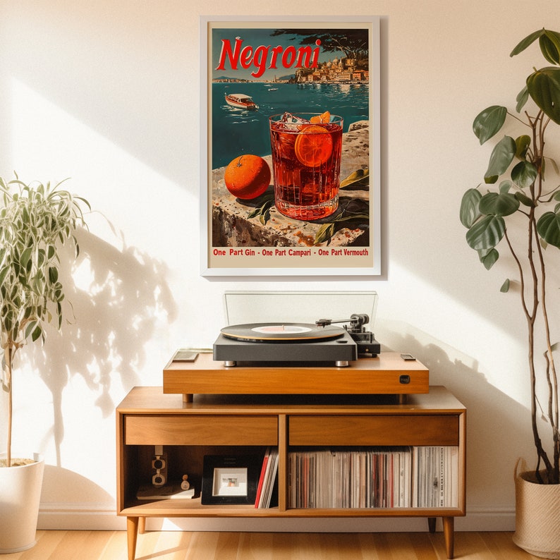 May include: A vintage poster advertising Negroni, a classic Italian cocktail. The poster features a glass of Negroni with an orange slice, against a backdrop of a picturesque Italian harbour. The text on the poster reads "Negroni" and "One Part Gin - One Part Campari - One Part Vermouth".