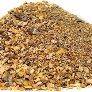 May include: A close-up of a pile of dried herbs and spices, including ginger, turmeric, and black peppercorns.