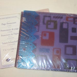 May include: A purple photo album with a geometric design and a package of page protectors. The album has a blue decorative edge. The page protectors are in a white package with text in multiple languages.