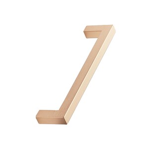 May include: A contemporary cabinet pull with an angled design, finished in brushed gold. The handle has a rectangular shape and a minimalist aesthetic. This cabinet pull is suitable for adding a touch of elegance to kitchens or bathrooms.