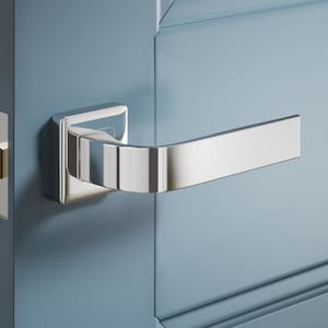 May include: A close-up shot of a contemporary door handle and lock. The handle is chrome-plated, with a square base and a flat, rectangular lever. The door is painted a muted blue, with visible panel detailing.