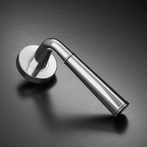 May include: A shiny chrome door handle with a curved lever and a circular base. The handle is angled, creating a shadow on the dark surface. The design is modern and minimalist.