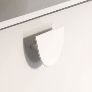 May include: White cabinet door with a half-circle shaped handle.