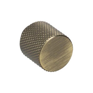 May include: A cylindrical cabinet knob with a textured, diamond-patterned body and a flat, circular end. The knob has a vintage brass finish, giving it an antique appearance. This hardware is suitable for drawers and cabinets.