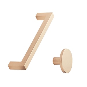 May include: A set of two brushed gold cabinet hardware pieces. The first piece is a 9.5 cm long, rectangular bar handle with a 90-degree bend. The second piece is a round knob with a short, cylindrical stem.