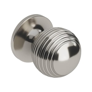 May include: A polished nickel door knob with a round, ridged handle and a circular base. The knob has a reflective surface, and the design is modern and minimalist. The hardware is likely for interior doors.
