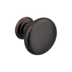 May include: A bronze cabinet knob with an oval shape and a circular base. The knob has a brushed finish, and the colour varies from dark brown to bronze. The hardware is designed for use on cabinets and drawers.