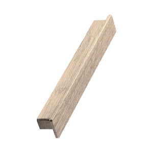 May include: A light brown wooden cabinet pull with a rectangular shape and a slightly angled edge. The pull has a smooth, slightly textured surface.