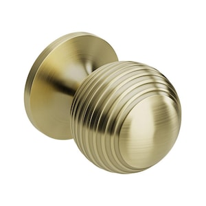 May include: A brass-toned door knob featuring a spherical, ridged handle and a circular base. The knob has a traditional design and a brushed finish. The hardware is likely for a door or cabinet.