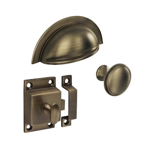 May include: A set of antique brass cabinet hardware, including a cup pull, a knob, and a latch. The hardware has a warm, aged finish, and is designed for use on cabinets and drawers.