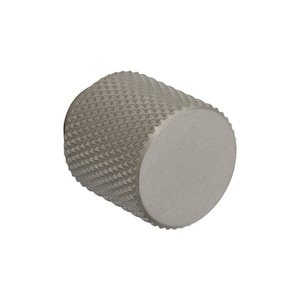 May include: A silver-toned, cylindrical knob featuring a textured, diamond-patterned grip. The knob has a flat, circular end. The design is simple and modern, suitable for various applications.