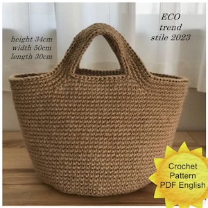 May include: A crocheted tote bag made of natural jute twine. The bag is brown and has a wide, rounded bottom. The bag measures 34 cm in height, 50 cm in width, and 30 cm in length. The bag has a single handle and is a great option for carrying groceries or other items.