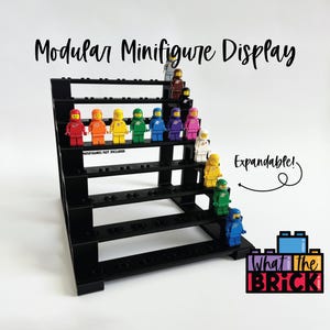 May include: A black tiered modular minifigure display stand with multiple rows for organizing small plastic figures. The text Modular Minifigure Display is at the top, and the word Expandable with an arrow points to the side. A logo reads What the Brick.