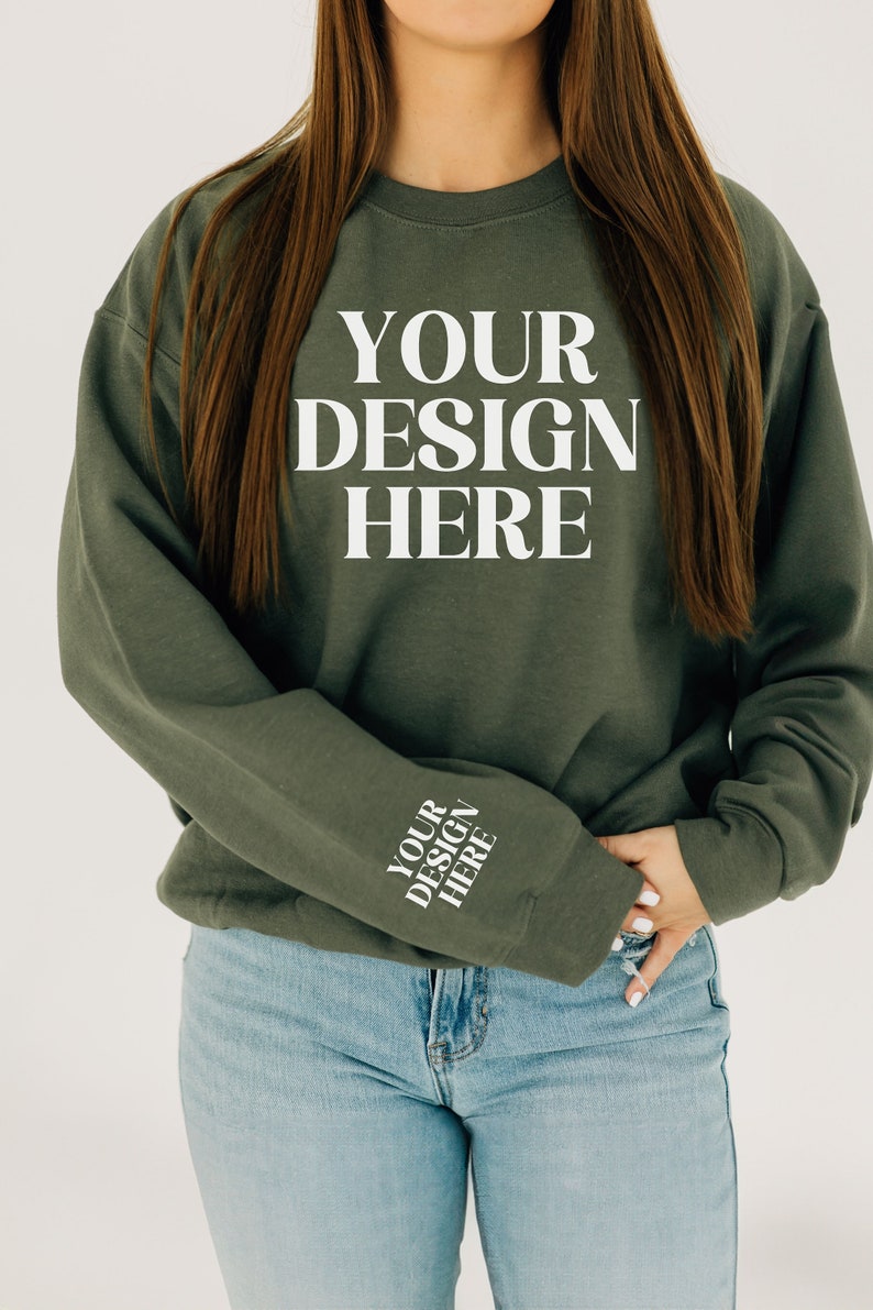 May include: A green sweatshirt with the text "YOUR DESIGN HERE" on the front and the same text on the left sleeve.