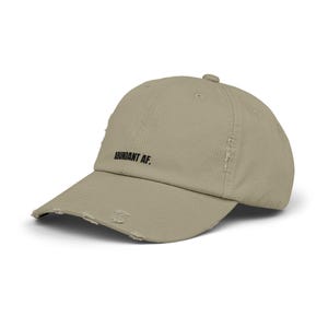 May include: A distressed, light brown baseball cap with the text "ABUNDANT AF." embroidered in black on the front.