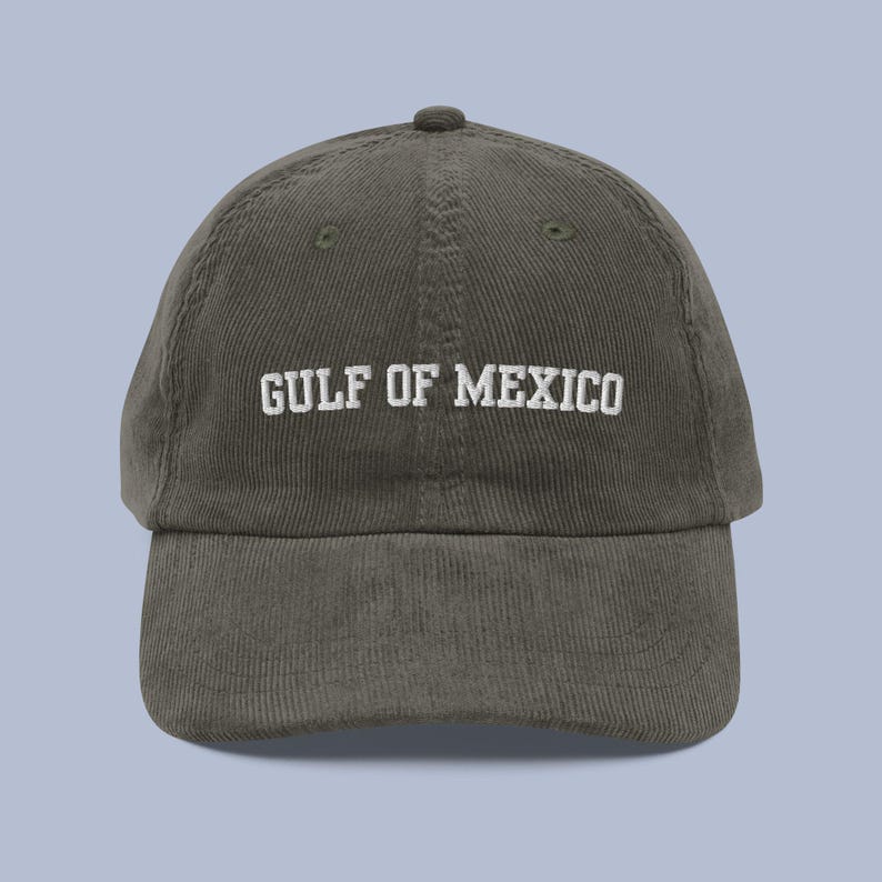 Pu&ograve; includere: Un cappello da baseball in velluto a coste verde scuro con testo ricamato bianco che recita "GULF OF MEXICO".