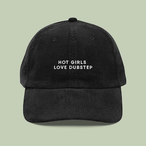 May include: Black corduroy baseball cap with white embroidered text that reads "HOT GIRLS LOVE DUBSTEP".