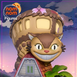 May include: A brown and white cat figurine with a large grin, sitting on top of a small white house with a red roof. The cat is holding a brown and tan flying house with a pink flower on top. The figurine is set on a green base.