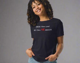 May include: A black t-shirt with the text "THEM: I love you! ME: I love ME more!!!" in white and red lettering. The t-shirt is a crew neck style.