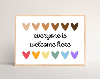 May include: A framed print with the text "everyone is welcome here" in black cursive font. The print features two rows of hearts in different skin tones and colors.