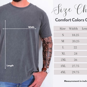 May include: A charcoal grey short-sleeve t-shirt shown with a size chart labeled Comfort Colors C1717. The chart lists sizes S through 4XL with corresponding width and length measurements in inches, indicated by white lines on the shirt.