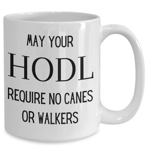 Puede incluir: Taza de café de cerámica blanca con texto negro que dice "May your HODL require no canes or walkers".