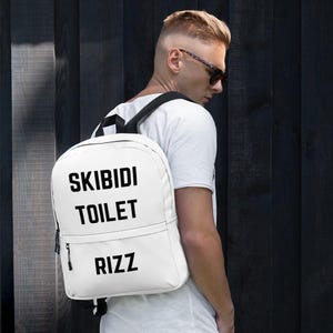 Skibidi トイレ リッツ バックパック、ティーン向けギフトのアイデア、ミームをテーマにしたスクール ペアレント バッグ