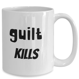 May include: White ceramic coffee mug with black text that reads "guilt kills".