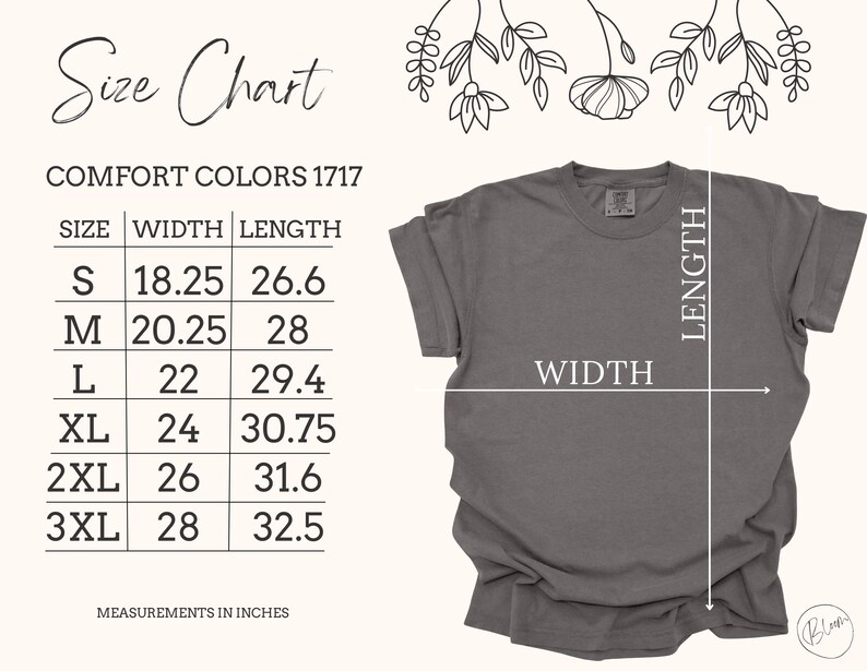 Op de afbeelding: Een grijs Comfort Colors 1717 t-shirt met een maattabel. De tabel toont maten S tot 3XL, met afmetingen in inches. De breedte en lengte van het shirt worden met pijlen aangegeven. Bloemenillustraties bovenaan.