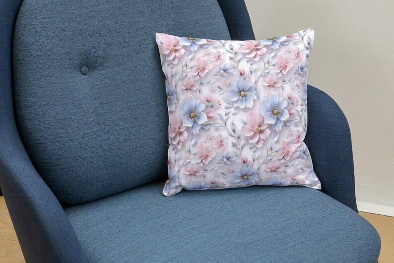 May include: A blue armchair with a white throw pillow featuring a floral pattern with pink and blue flowers.