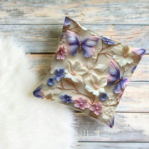 May include: A decorative pillow with a floral design featuring butterflies, flowers, and leaves in shades of pink, purple, and white.