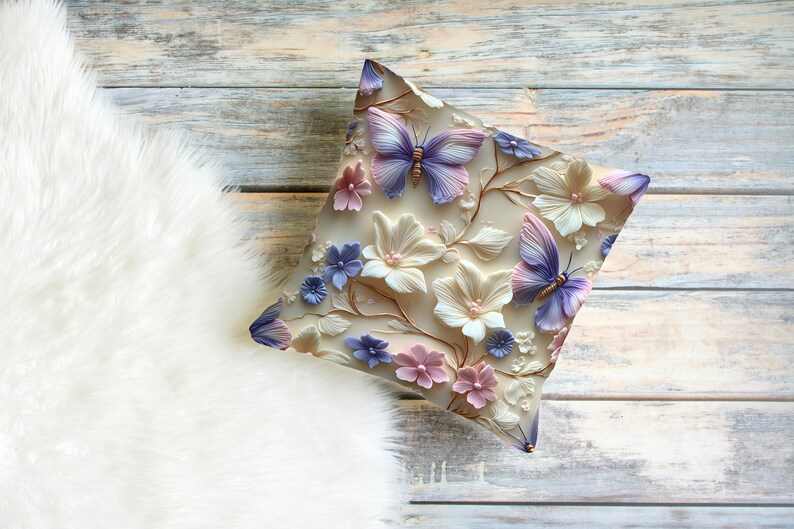 May include: A decorative pillow with a floral design featuring butterflies, flowers, and leaves in shades of pink, purple, and white.