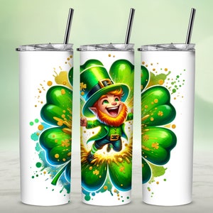 May include: A white stainless steel tumbler with a green four-leaf clover design. A cartoon leprechaun wearing a green hat and holding a pot of gold is jumping in the center of the clover. The background is a watercolor wash of green, blue, and gold.