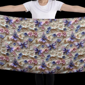 May include: A white scarf with a floral and butterfly pattern. The butterflies are purple and blue with white accents. The flowers are pink and white.