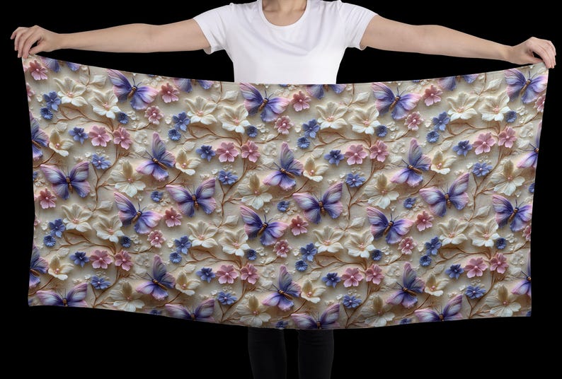 May include: A white scarf with a floral and butterfly pattern. The butterflies are purple and blue with white accents. The flowers are pink and white.
