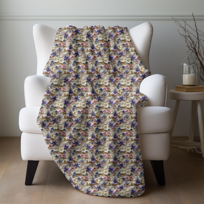 May include: A soft, cream-colored throw blanket with a repeating pattern of purple and pink butterflies and flowers.