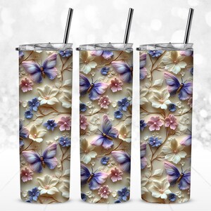 May include: Three stainless steel tumblers with a white background and a floral design featuring pink, purple, and blue butterflies.